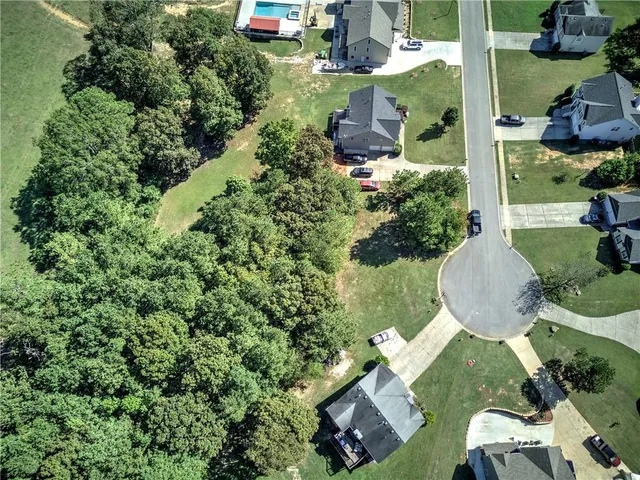 an aerial view of a house with yard swimming pool and outdoor seating