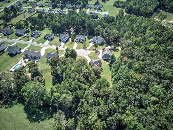 an aerial view of residential house with yard and outdoor space