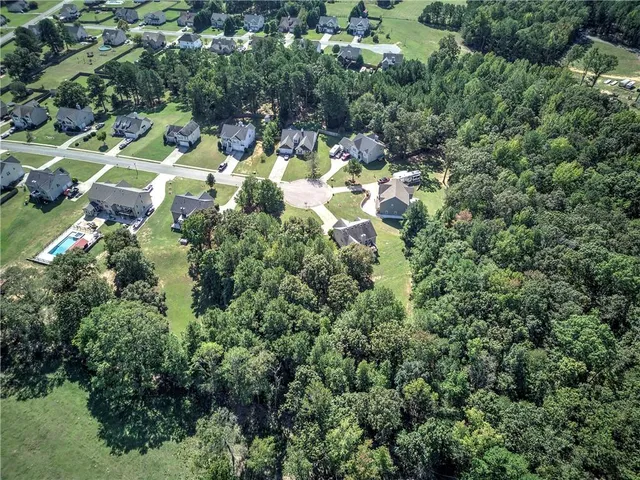 an aerial view of residential house with yard and outdoor space