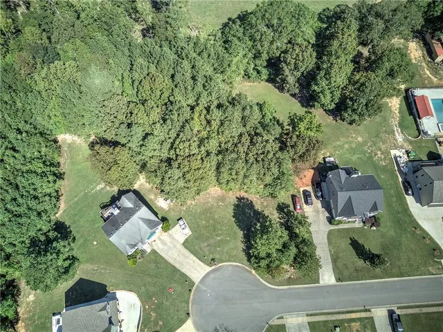 an aerial view of a house with yard