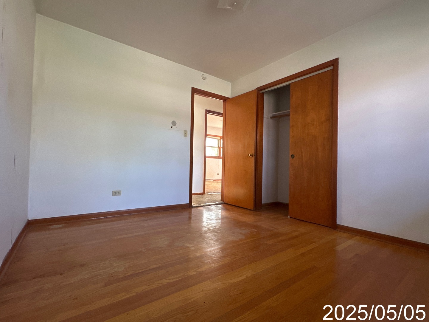 9276 North Western Avenue Des Plaines, IL 60016 - Photo 13 of 18 an empty room with wooden floor and windows