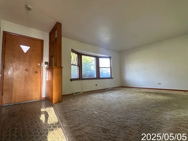 a view of a livingroom with a ceiling fan and window