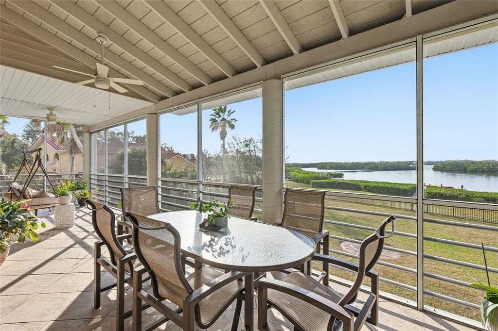 6511 Bayshore Road Palmetto, FL 34221 - Photo 16 of 53 a view of a dining room with furniture large windows and wooden floor