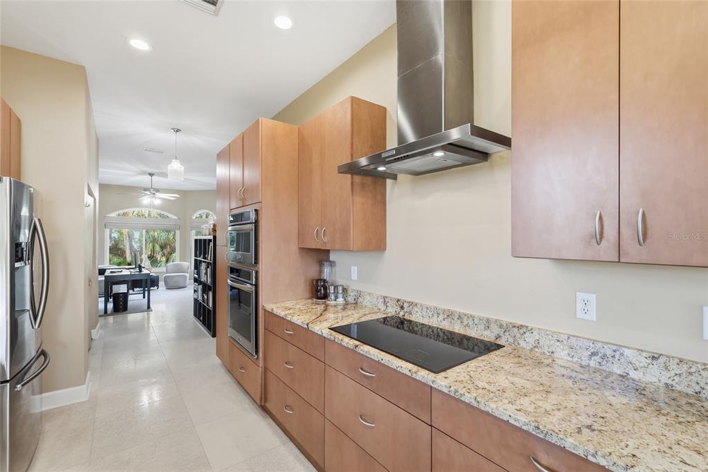 6511 Bayshore Road Palmetto, FL 34221 - Photo 21 of 53 a kitchen with stainless steel appliances granite countertop a sink stove and refrigerator