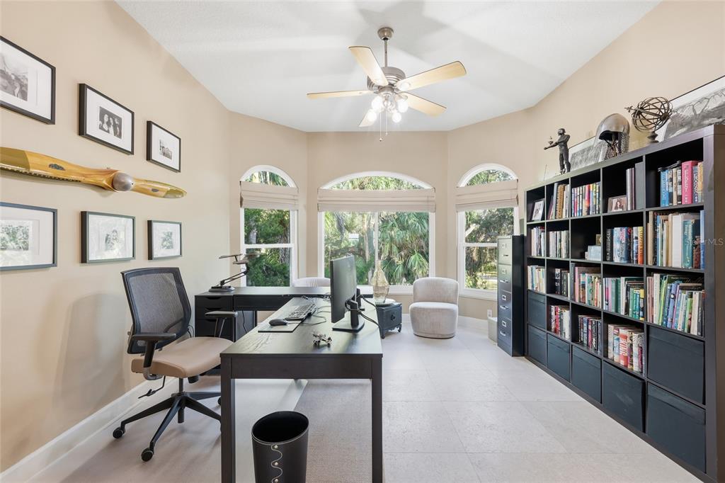 6511 Bayshore Road Palmetto, FL 34221 - Photo 23 of 53 a living room with furniture and a book shelf