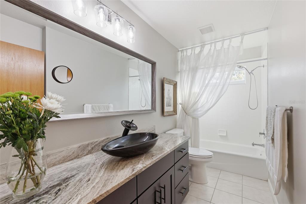 6511 Bayshore Road Palmetto, FL 34221 - Photo 25 of 53 a bathroom with a sink a toilet and shower