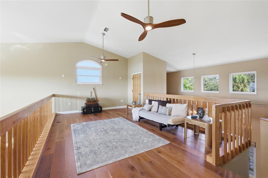 6511 Bayshore Road Palmetto, FL 34221 - Photo 27 of 53 a living room with furniture and a wooden floor