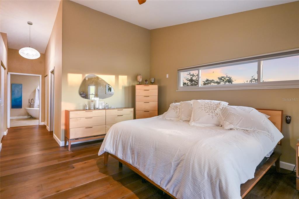 6511 Bayshore Road Palmetto, FL 34221 - Photo 32 of 53 a bedroom with a bed and a view of bathroom