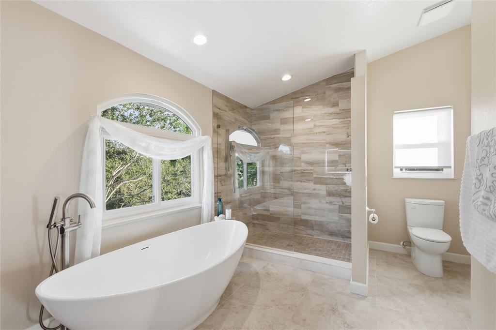 6511 Bayshore Road Palmetto, FL 34221 - Photo 33 of 53 a bathroom with a bathtub and a shower