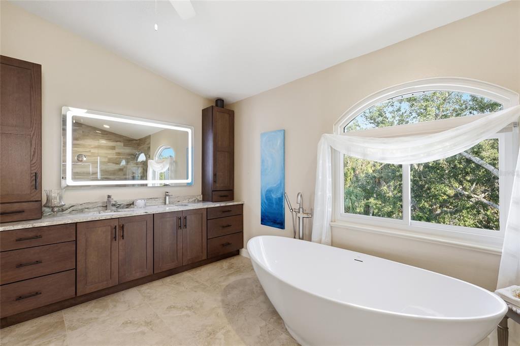 6511 Bayshore Road Palmetto, FL 34221 - Photo 34 of 53 a view of a bathroom with a tub sink and mirror