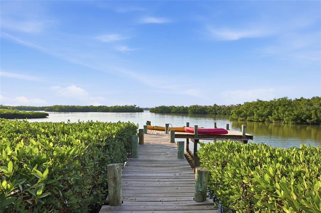 6511 Bayshore Road Palmetto, FL 34221 - Photo 9 of 53 a view of a lake with a bench next to a lake