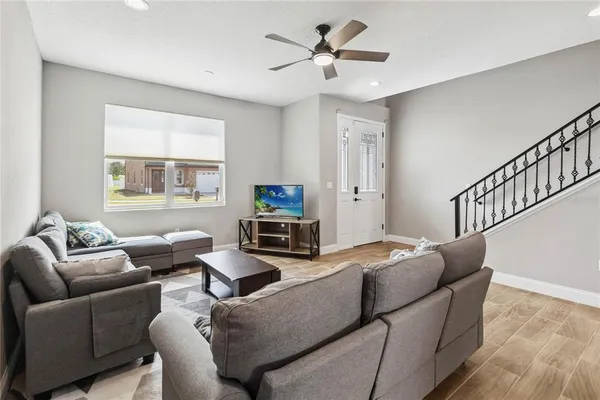 a living room with furniture a fireplace and a flat screen tv