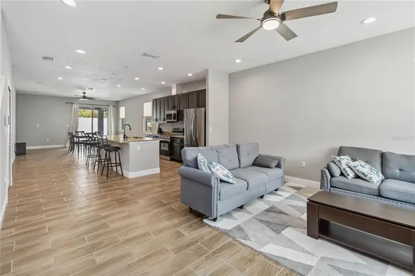 a living room with furniture and kitchen view