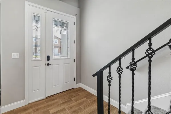 a view of an entryway with wooden floor and stairs