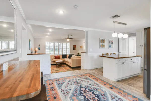 a large kitchen with a table and chairs in it