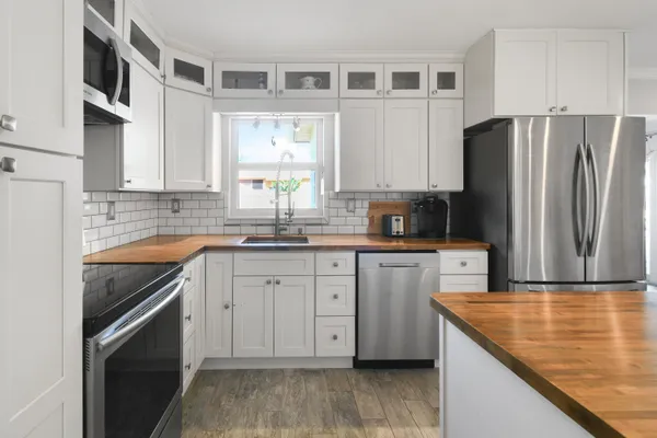 a large kitchen with a table and chairs