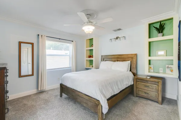 a bedroom with a bed and a chandelier