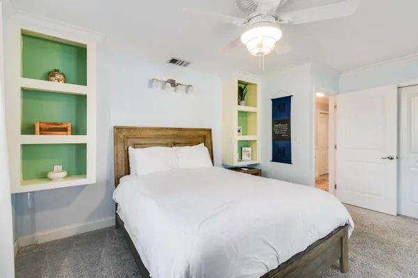 a bedroom with a bed and a chandelier