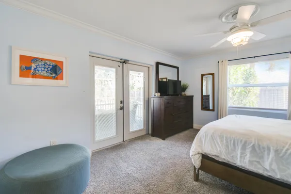 a bedroom with a large bed and a chandelier