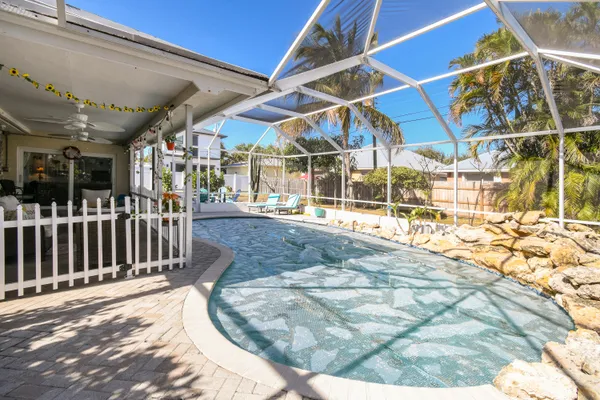 a swimming pool with outdoor seating and patio