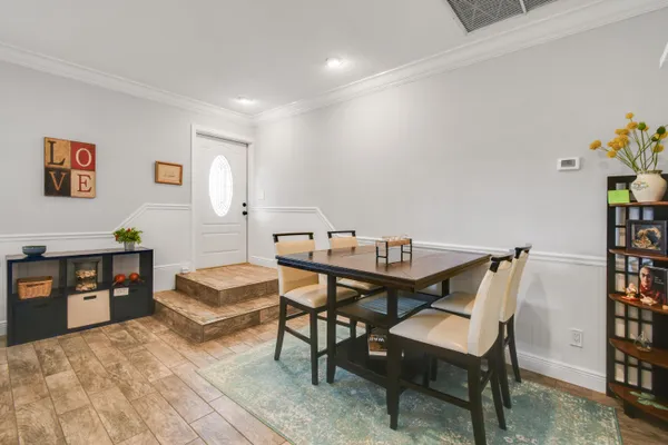 a view of a dining room with furniture and wooden floor