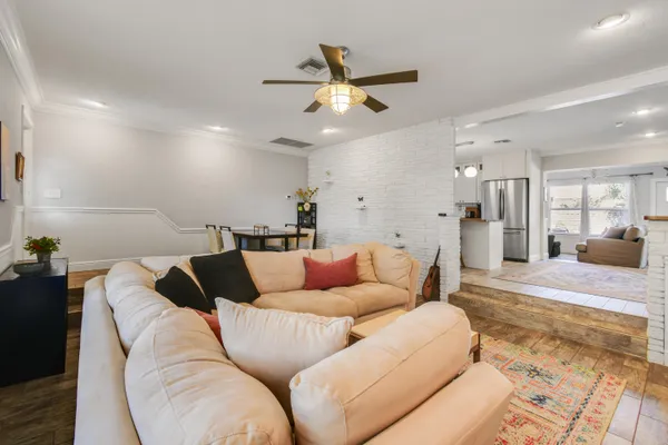 a living room with furniture and kitchen view