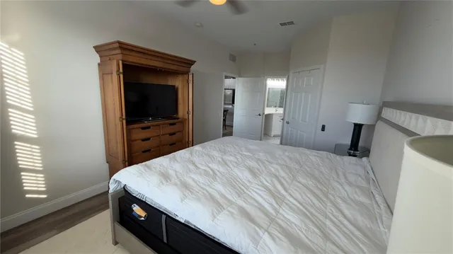 a bedroom with a bed and a large window