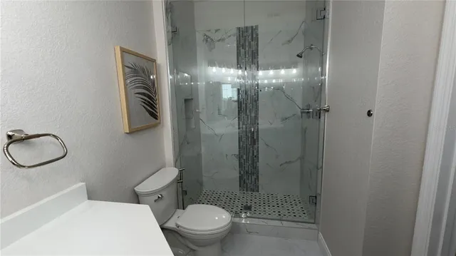 a kitchen with stainless steel appliances a stove a microwave a sink and white cabinets