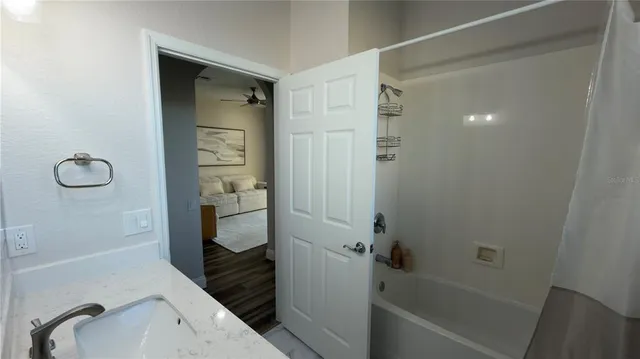 a view of a house with a big yard and large trees