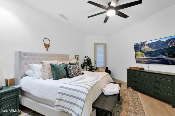 a bedroom with a bed and a chandelier