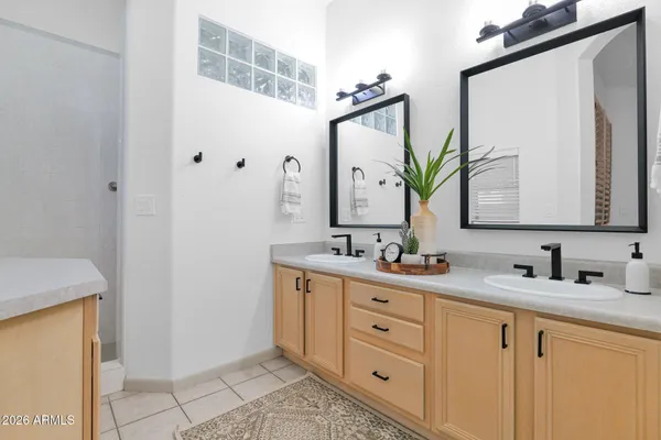 a bathroom with a double vanity sink and mirror