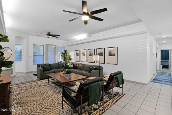 a living room with furniture a dining table and a piano