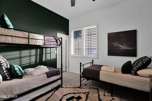 a bedroom with furniture and a window