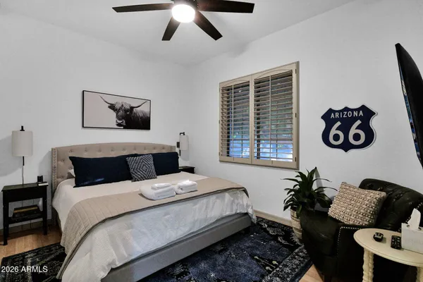 a bedroom with a bed and wooden floor