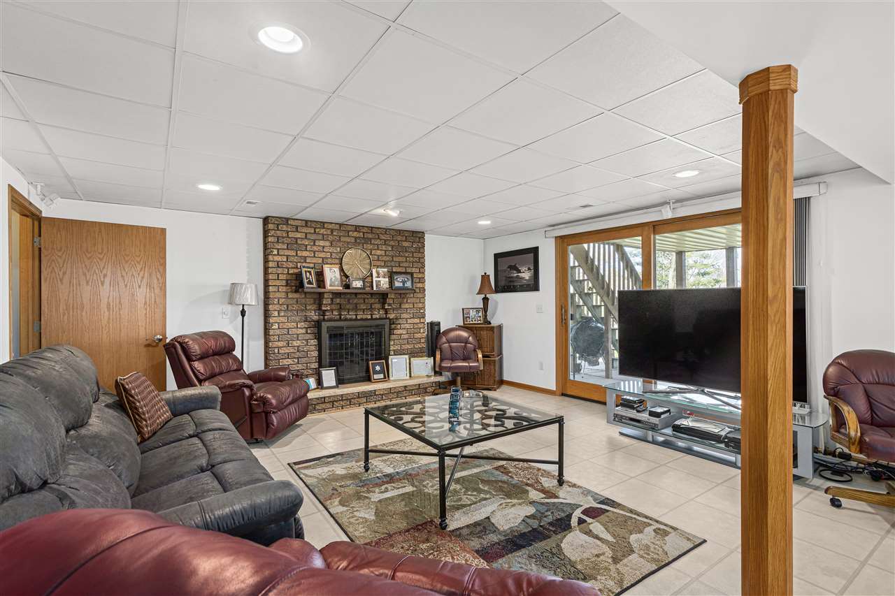 1947 Baintree Road Lake Summerset, IL 61019 - Photo 19 of 53 a living room with furniture a floor to ceiling window and a flat screen tv