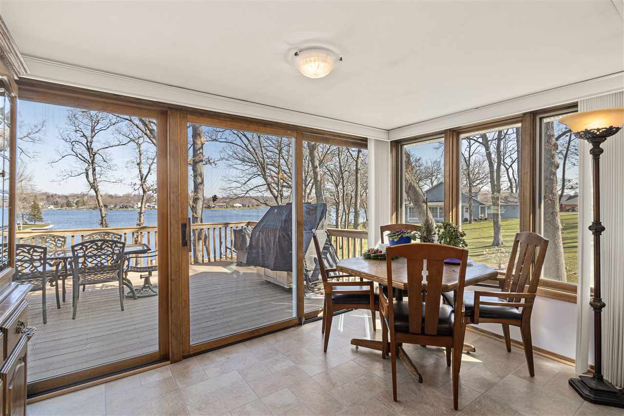 1947 Baintree Road Lake Summerset, IL 61019 - Photo 5 of 53 a view of a dining room with furniture large windows and wooden floor