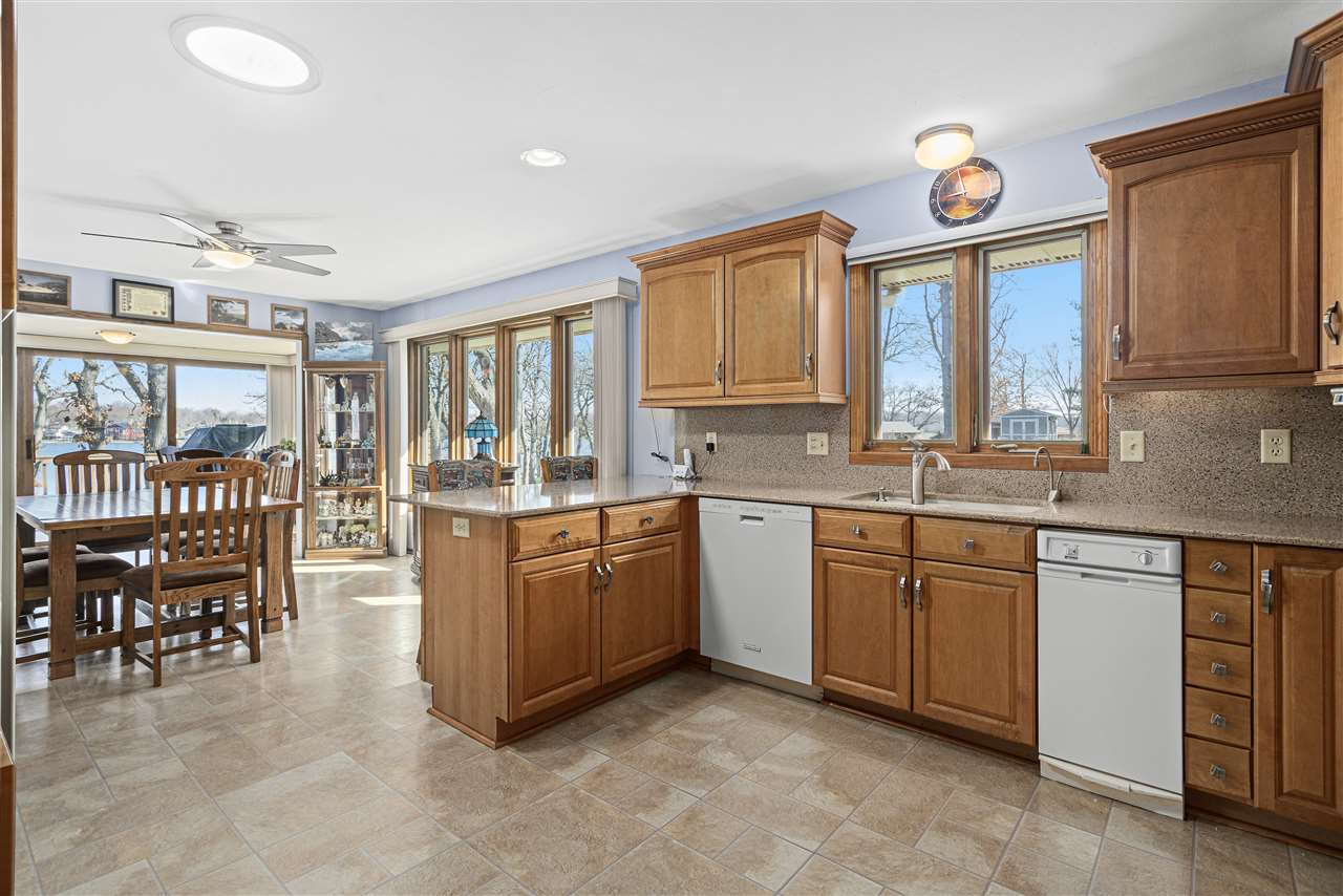 1947 Baintree Road Lake Summerset, IL 61019 - Photo 9 of 53 a large kitchen with kitchen island granite countertop a large window and a sink