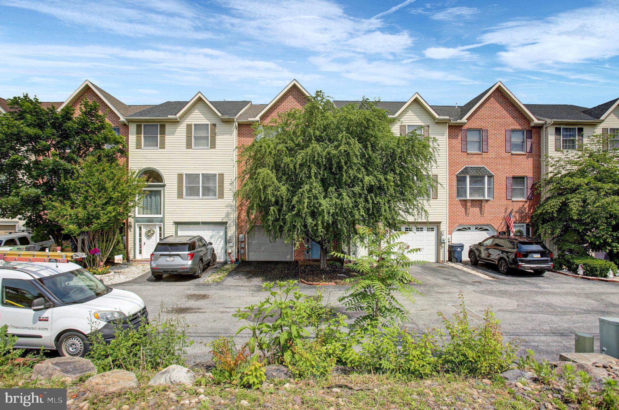 1557 Brechbill Road Chambersburg, PA 17202 - Photo 1 of 33 Charming townhomes with lush greenery.