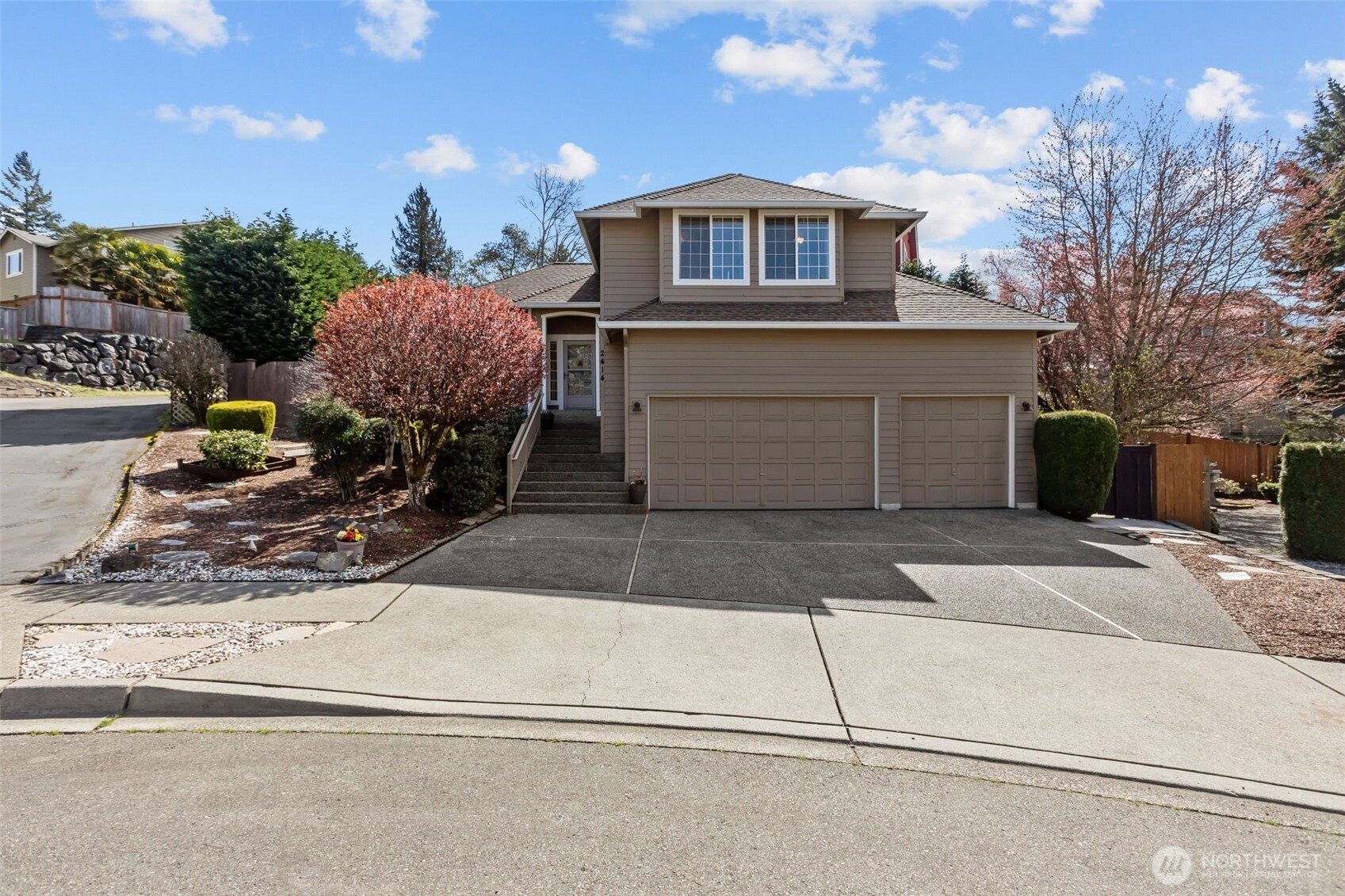 2414 Kennewick Place Northeast Renton, WA 98056 - Photo 1 of 40 a front view of a house with a yard and garage
