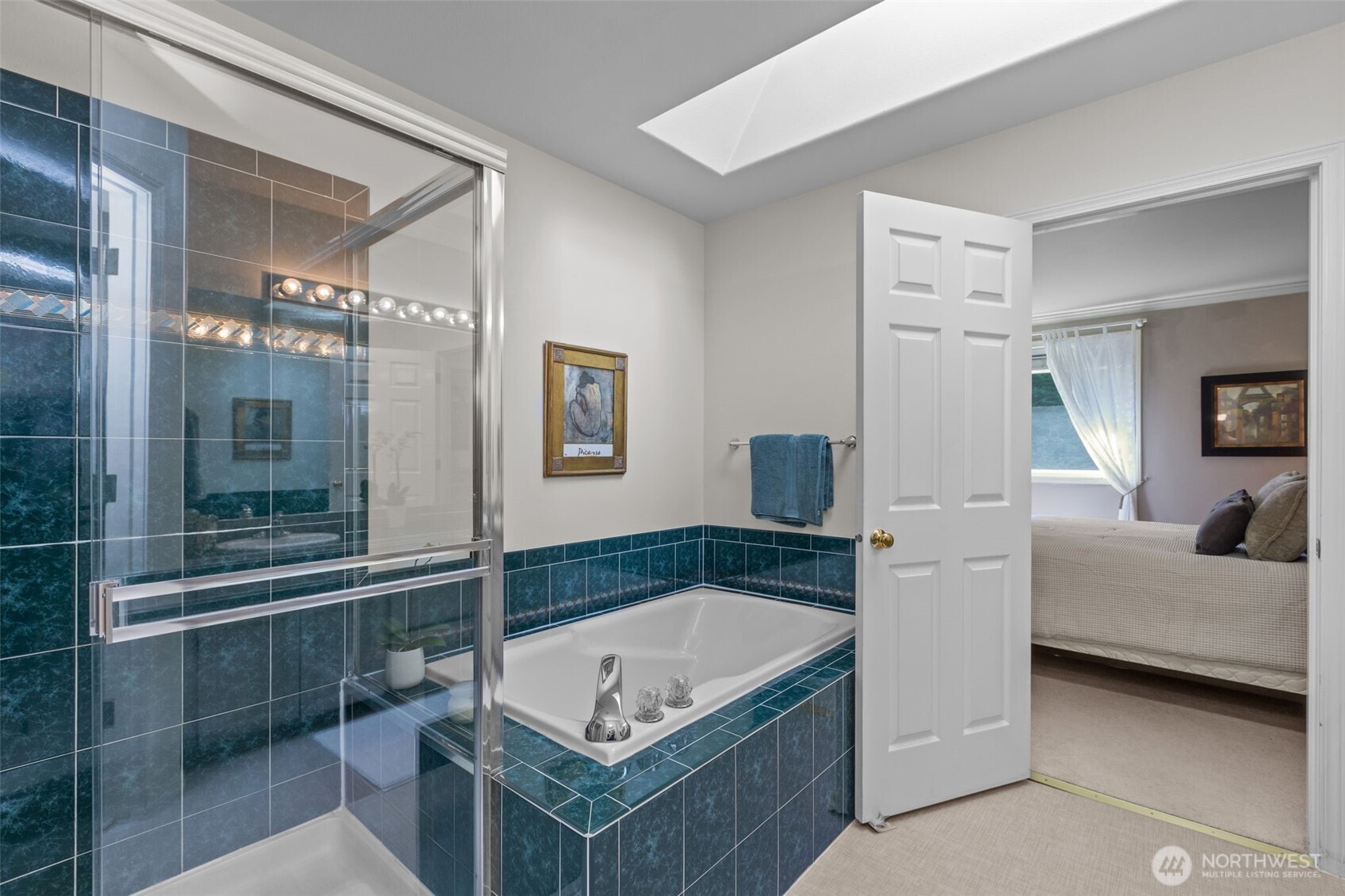 2414 Kennewick Place Northeast Renton, WA 98056 - Photo 22 of 40 a spacious bathroom with a tub shower and mirror