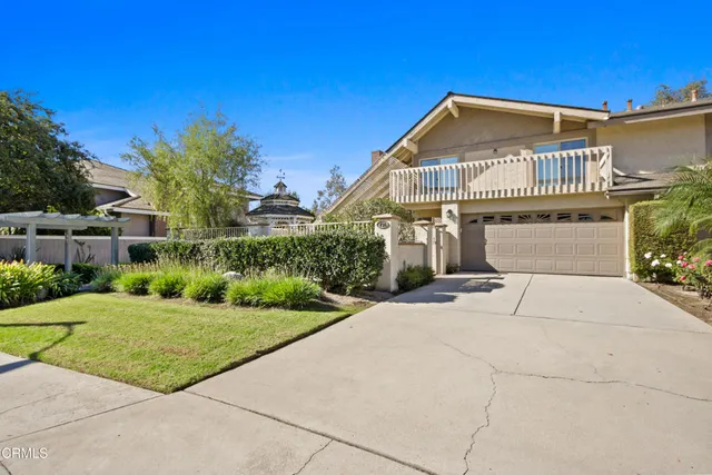 a view of a big building with a big yard and large trees