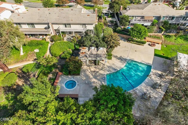 an aerial view of a house with yard and street