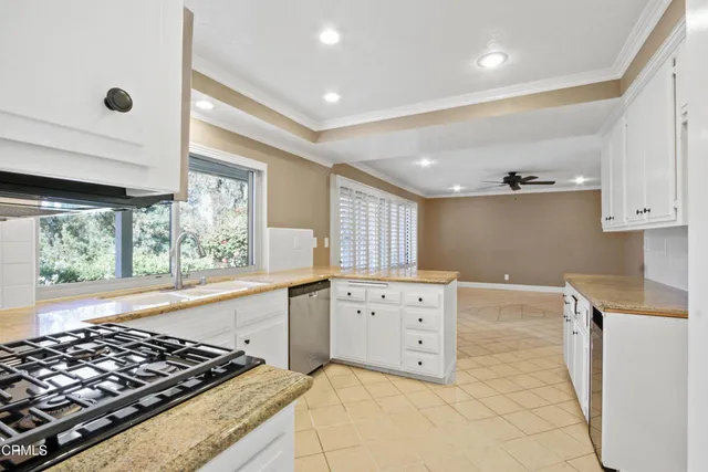 a kitchen with stainless steel appliances granite countertop a stove and a refrigerator