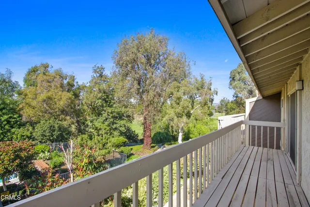 a view of a balcony with wooden fence