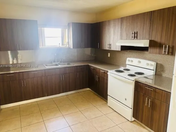 a kitchen with a cabinets and white appliances