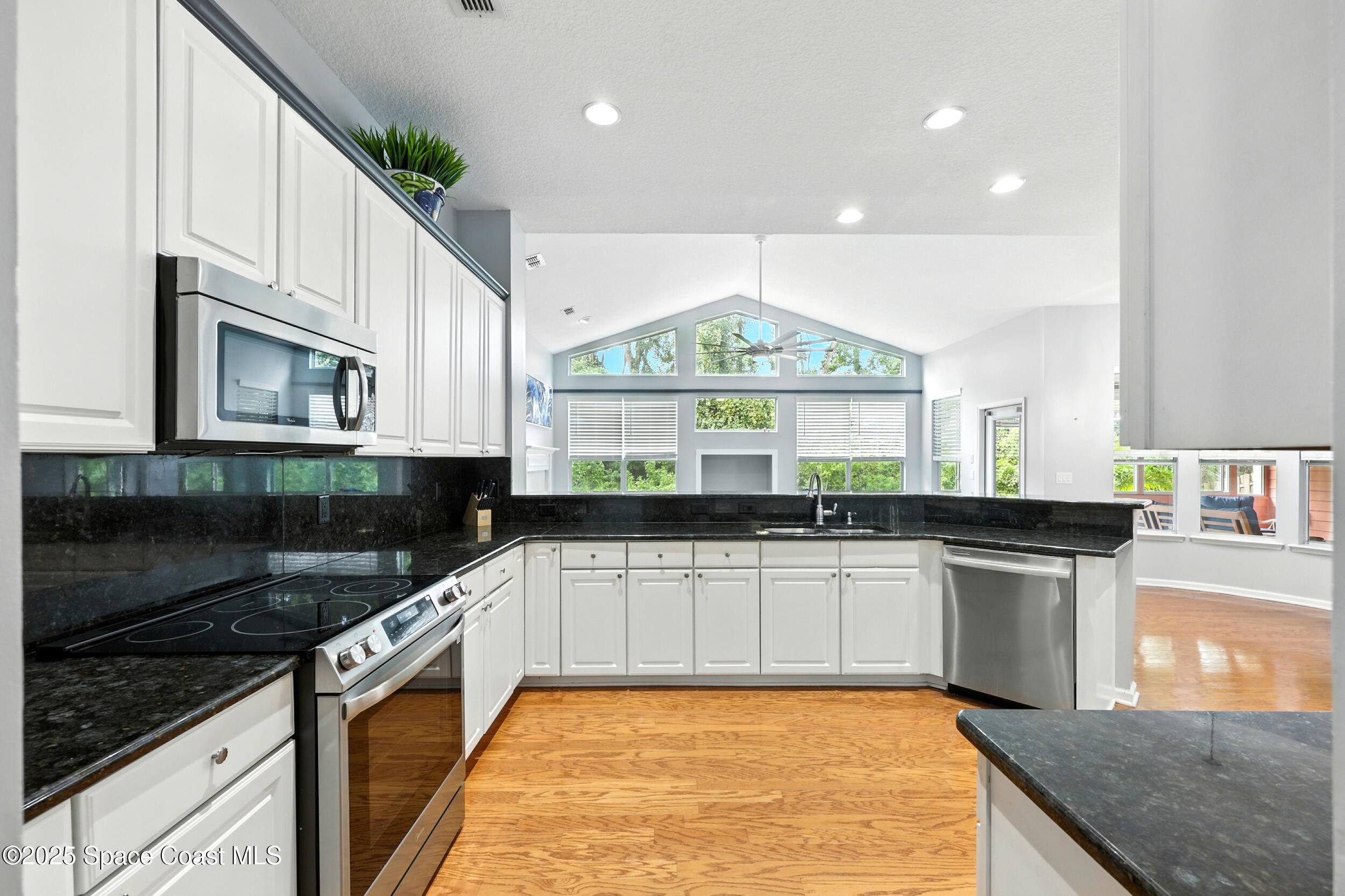 2560 Benjamin Road Jacksonville, FL 32223 - Photo 17 of 48 a kitchen with stainless steel appliances a sink stove and cabinets