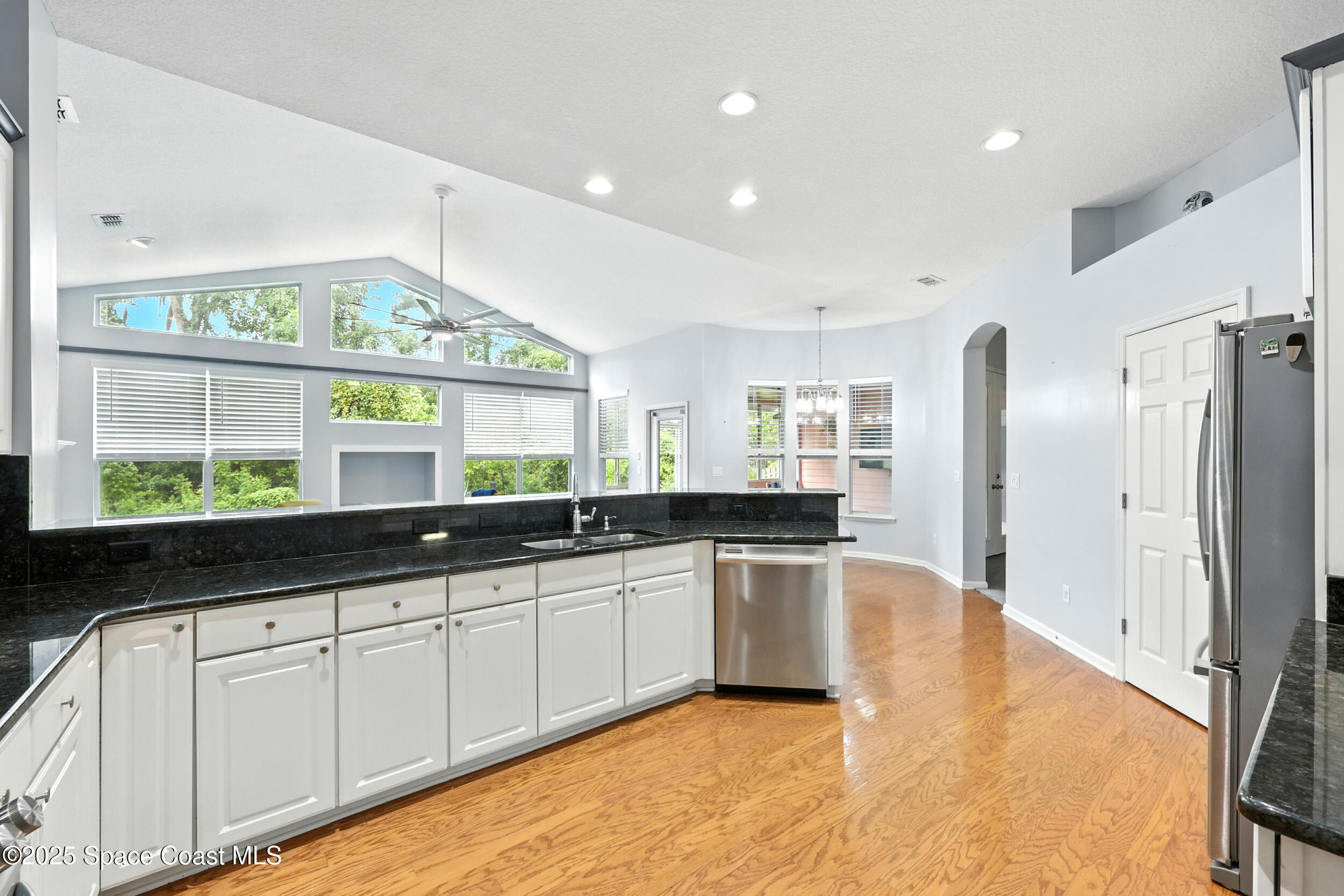2560 Benjamin Road Jacksonville, FL 32223 - Photo 18 of 48 a large kitchen with stainless steel appliances a large counter top a stove a sink and a refrigerator
