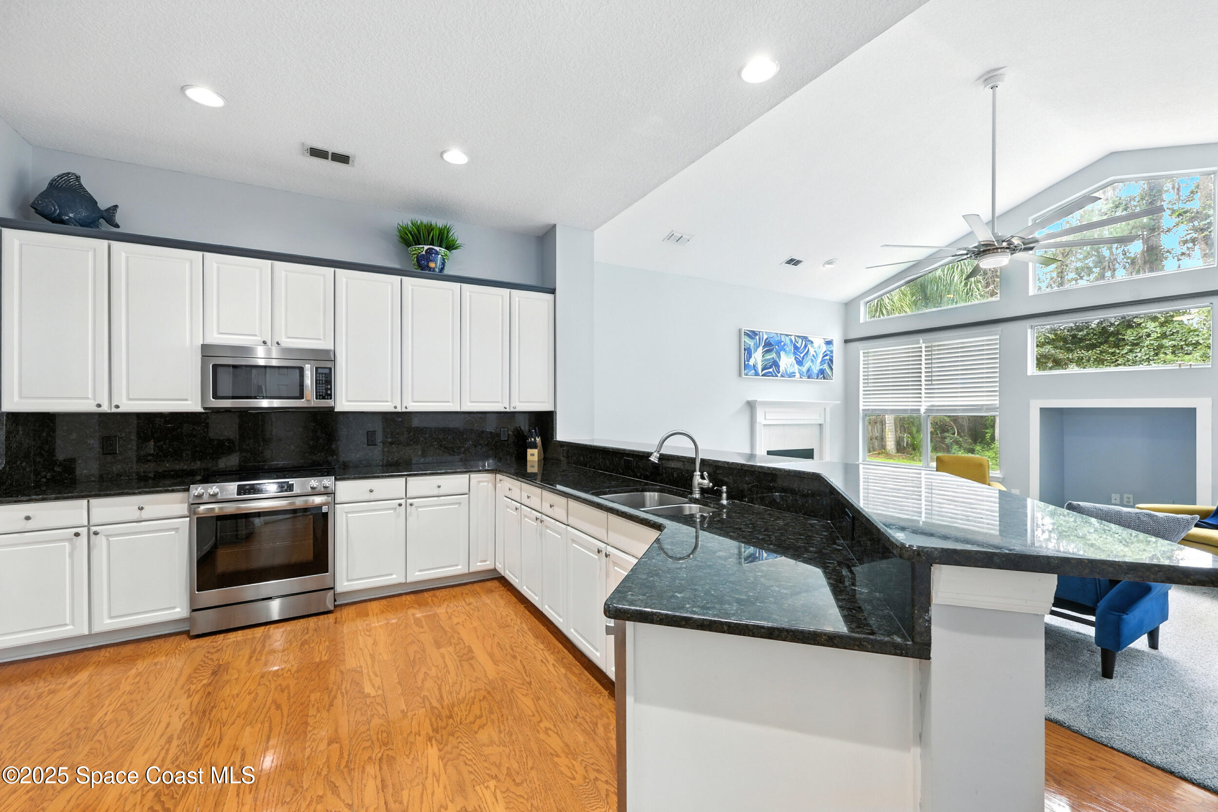 2560 Benjamin Road Jacksonville, FL 32223 - Photo 19 of 48 a kitchen with granite countertop a sink and a stove top oven