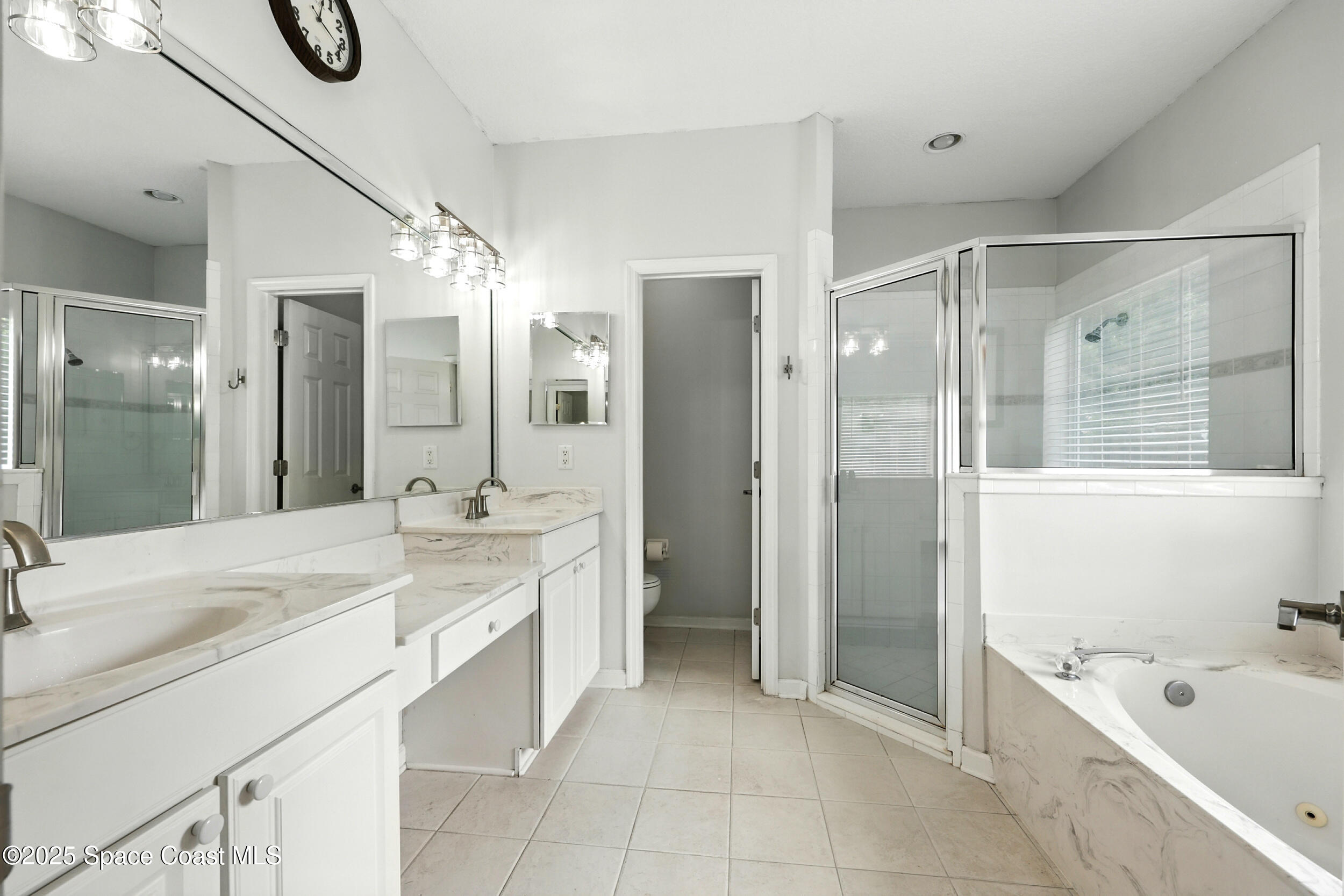 2560 Benjamin Road Jacksonville, FL 32223 - Photo 25 of 48 a spacious bathroom with a shower sink and mirror