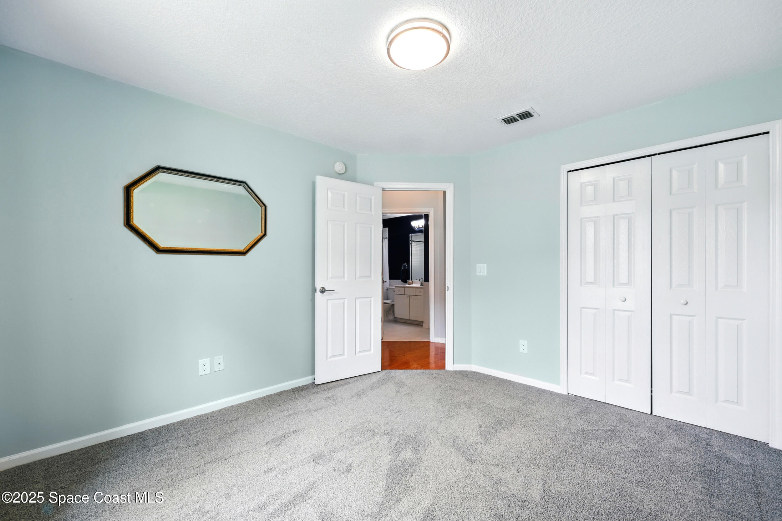 2560 Benjamin Road Jacksonville, FL 32223 - Photo 33 of 48 an empty room with cabinet and mirror
